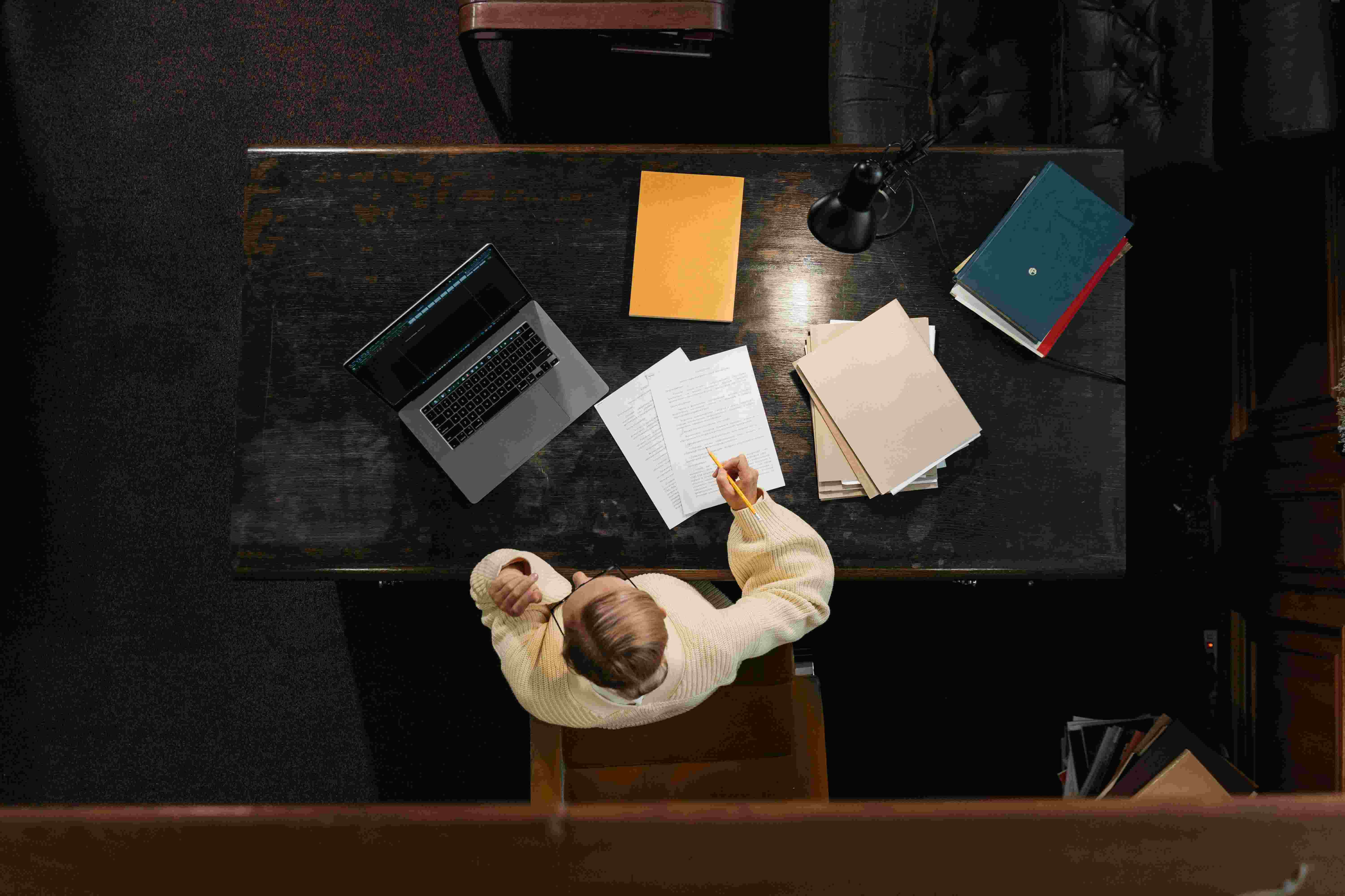A working desk with laptop and notes